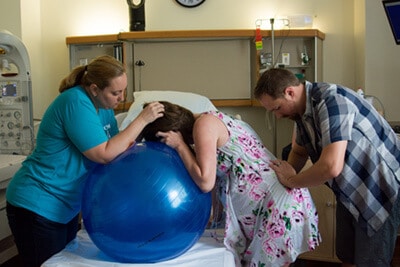 Heather Whitcomb supporting a Doula client during labor.